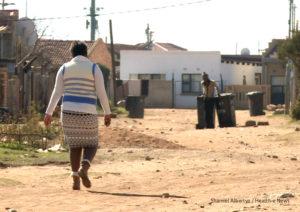 Sophia Molefe, who refuses to take her Schizophrenia medication, walks through the streets of Snake Park, Soweto.
